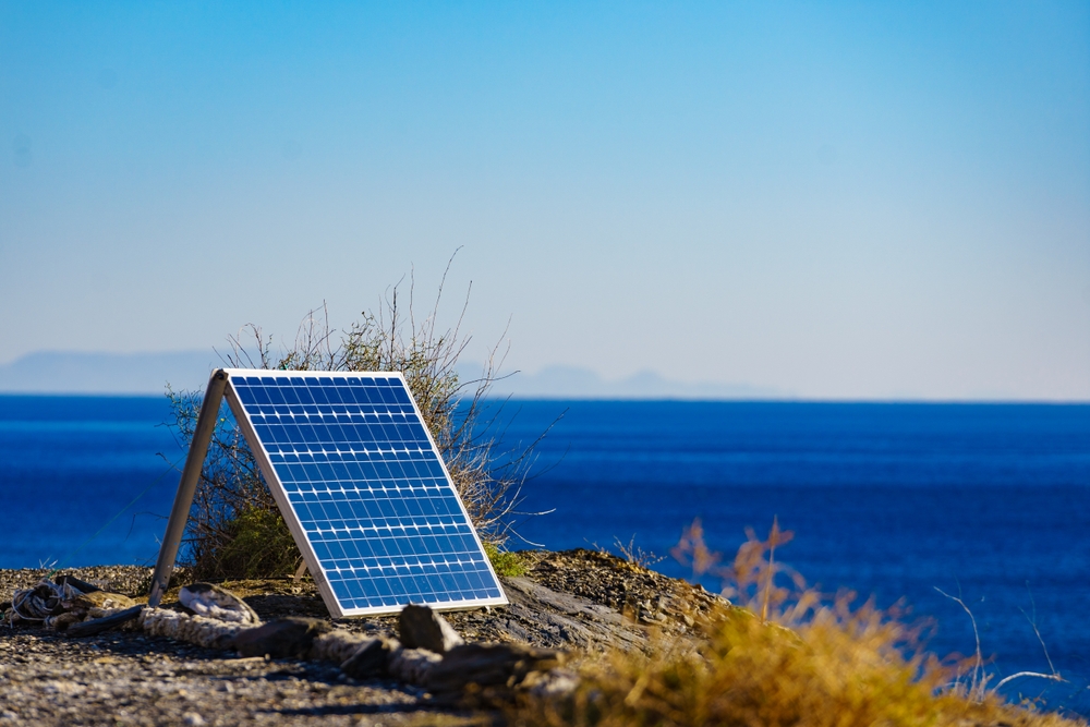 Single,Solar,Photovoltaic,Panels,,Charging,Batteries,Outdoors,On,Sea,Shore.